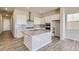 Stylish kitchen featuring a large island, stainless steel appliances, and subway tile backsplash at 14136 Bunny Hop Ln, Parker, CO 80134