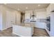 Modern kitchen with an island, stainless steel appliances, and white cabinetry at 14136 Bunny Hop Ln, Parker, CO 80134