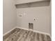 A utility room with wood-look vinyl flooring and convenient washer and dryer hookups and an above shelf at 14136 Bunny Hop Ln, Parker, CO 80134