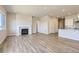 Open living room featuring a fireplace and wood-look flooring and open to the kitchen at 14136 Bunny Hop Ln, Parker, CO 80134