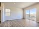 Bright living room with wood-look floors, sliding door, and windows providing natural light at 14136 Bunny Hop Ln, Parker, CO 80134