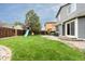 Spacious backyard showcasing a play set with slide, plus a patio and green lawn at 2763 Dharma Ave, Broomfield, CO 80020