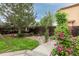 Landscaped backyard featuring a beautiful flower garden, large tree, and stone accents at 2763 Dharma Ave, Broomfield, CO 80020