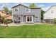 Wide view of the home's backyard, featuring a well maintained lawn and patio area with furniture at 2763 Dharma Ave, Broomfield, CO 80020
