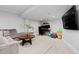 Finished basement featuring a gray sofa, entertainment center, and plush carpet at 2763 Dharma Ave, Broomfield, CO 80020