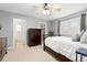 Spacious bedroom with carpeted floors, a ceiling fan, and an ensuite bathroom at 2763 Dharma Ave, Broomfield, CO 80020