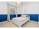 Stylish bedroom with white and blue walls, a cozy bed, and ample natural light at 2763 Dharma Ave, Broomfield, CO 80020