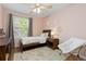 Charming bedroom featuring a cozy bed, a window with natural light, and decorative floral accents for a serene atmosphere at 2763 Dharma Ave, Broomfield, CO 80020