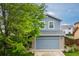 Charming two-story home with a well-maintained lawn, mature tree, and attached two-car garage at 2763 Dharma Ave, Broomfield, CO 80020