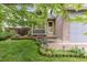 Charming home exterior showcasing a landscaped front yard with vibrant flower beds at 2763 Dharma Ave, Broomfield, CO 80020