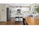 Contemporary kitchen showcasing white cabinetry, granite countertops, stainless steel appliances, and island seating at 2763 Dharma Ave, Broomfield, CO 80020