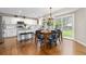 Bright kitchen features white cabinetry, stainless steel appliances, and an adjacent dining area with backyard access at 2763 Dharma Ave, Broomfield, CO 80020