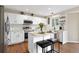 Modern kitchen featuring white cabinets, granite countertops, stainless steel appliances, and a central island at 2763 Dharma Ave, Broomfield, CO 80020