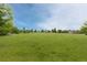 Beautiful green lawn and tree-lined walking path in the community at 2763 Dharma Ave, Broomfield, CO 80020