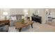 Cozy living room featuring neutral tones, modern furnishings, and a view into the kitchen at 2763 Dharma Ave, Broomfield, CO 80020
