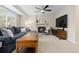 Spacious living room features a fireplace, large TV, comfortable seating, and ample natural light from the window at 2763 Dharma Ave, Broomfield, CO 80020