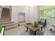 Comfortable living room with staircase, coat rack with bench, and bright natural light at 2763 Dharma Ave, Broomfield, CO 80020