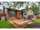 Large backyard deck with outdoor seating, wooden benches, and access to the lawn at 10154 W Hawaii Pl, Lakewood, CO 80232