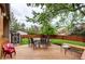 Backyard deck features ample seating, a green lawn, and mature trees at 10154 W Hawaii Pl, Lakewood, CO 80232