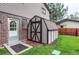 Backyard storage shed with dark trim and a white door provides extra storage at 10154 W Hawaii Pl, Lakewood, CO 80232