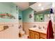 Bathroom featuring light turquoise walls, a sink, and a toilet at 10154 W Hawaii Pl, Lakewood, CO 80232