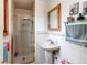 Clean bathroom with a glass shower and a pedestal sink with a mirror at 10154 W Hawaii Pl, Lakewood, CO 80232