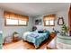 Light bedroom with hardwood floors, natural light, and warm toned accents at 10154 W Hawaii Pl, Lakewood, CO 80232