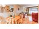 Bright dining area with hardwood floors, modern mirror, and view into the living room at 10154 W Hawaii Pl, Lakewood, CO 80232