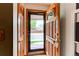 View of the home's entry featuring a wood door with decorative glass and a storm door at 10154 W Hawaii Pl, Lakewood, CO 80232