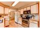 Traditional kitchen with white cabinets, stainless steel appliances, and tile floors at 10154 W Hawaii Pl, Lakewood, CO 80232