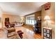 Open living room featuring hardwood floors, comfortable seating, and a large window for natural light at 10154 W Hawaii Pl, Lakewood, CO 80232