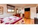 Comfortable main bedroom with hardwood floors, dresser, and ensuite bathroom at 10154 W Hawaii Pl, Lakewood, CO 80232