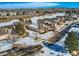 Aerial view of house and neighborhood in winter at 671 Stafford Cir, Castle Rock, CO 80104