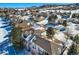 Aerial view of house and neighborhood in snow at 671 Stafford Cir, Castle Rock, CO 80104