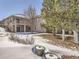 Snowy backyard with deck and landscaping at 671 Stafford Cir, Castle Rock, CO 80104