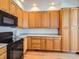 Well-equipped kitchen with ample wood cabinets and granite countertops at 671 Stafford Cir, Castle Rock, CO 80104