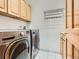 Laundry room with washer, dryer, cabinets, and a hanging rack at 671 Stafford Cir, Castle Rock, CO 80104