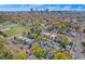 An aerial view of a neighborhood filled with colorful trees and downtown in the background at 2841 N Franklin St, Denver, CO 80205