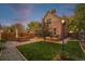 Spacious backyard with manicured lawn, patio area, and ambient outdoor lighting at 2841 N Franklin St, Denver, CO 80205