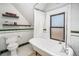 Bathroom features a clawfoot tub, subway tile, and classic fixtures at 2841 N Franklin St, Denver, CO 80205