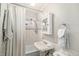 Cozy bathroom with vintage fixtures, tile surround, and a shower curtain at 2841 N Franklin St, Denver, CO 80205