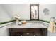 Charming bathroom featuring marble countertop, dark wood vanity, and decorative mirrors at 2841 N Franklin St, Denver, CO 80205