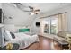 Bright bedroom features hardwood floors, a ceiling fan, and a large window with light-filtering curtains at 2841 N Franklin St, Denver, CO 80205