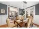 Stylish dining room with decorative wainscoting, pendant lights, and an inviting view to a cozy living room at 2841 N Franklin St, Denver, CO 80205