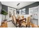 Light-filled dining room featuring a dark accent wall, crisp white trim, and bright windows at 2841 N Franklin St, Denver, CO 80205