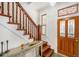 Welcoming foyer featuring a staircase with wood railings, complemented by stylish decor at 2841 N Franklin St, Denver, CO 80205