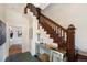 Classic foyer with a wooden staircase, decorative table, and a glimpse into adjacent rooms at 2841 N Franklin St, Denver, CO 80205