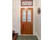 Elegant wooden front door with decorative glass panels and a transom window at 2841 N Franklin St, Denver, CO 80205