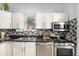 Well-lit kitchen featuring stainless steel appliances, mosaic tile backsplash, and ample counter space at 2841 N Franklin St, Denver, CO 80205