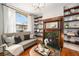 Bright living room with a fireplace, shelving, and ample natural light creating a warm ambiance at 2841 N Franklin St, Denver, CO 80205